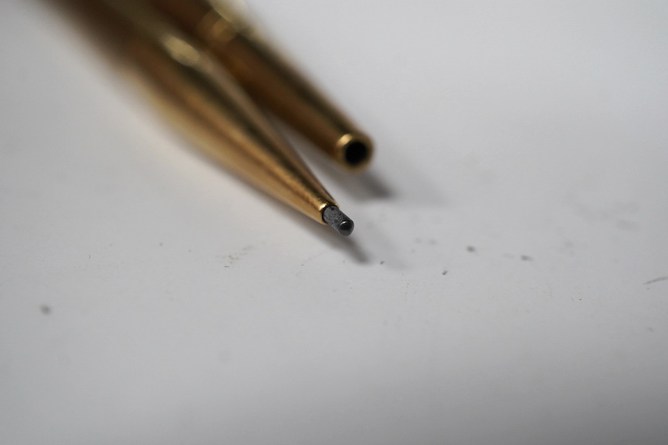 Two engine turned 9ct gold pencils, hallmarked for London, 1959 and London, 1969, both approx. 11.8cm. Condition - fair to good